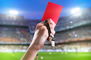 Hand of referee with red card.